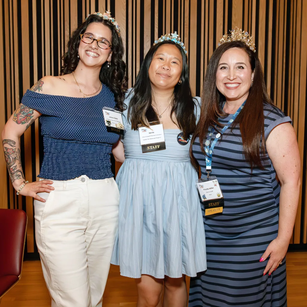 2026 Upwell Chair Kat So (center) celebrates passing the tiara to 2027 Upwell Chair Priscilla Miller (right) and 2027 Deputy Chair Green 2.0's Juliana Ojeda (left)
